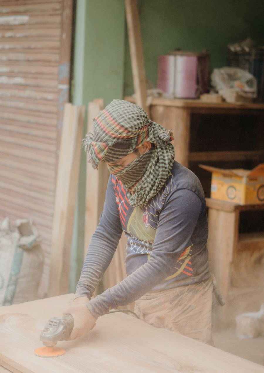 Carpenter sanding a wooden surface
