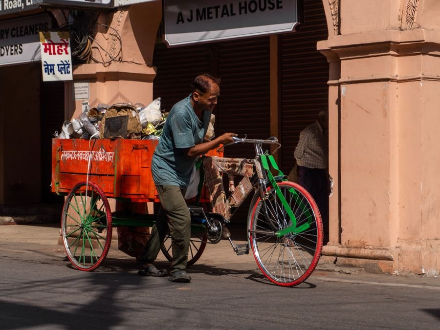 Indian worker collecting recyclables on a city street